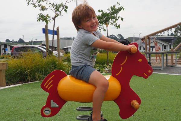 Boy on a rocking horse at The Lakes Tauranga